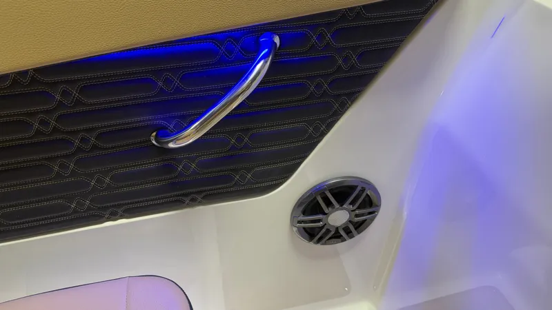 Slide: The Image of Close-up of a boat interior with blue lighting, a speaker, and a grab handle. - 43