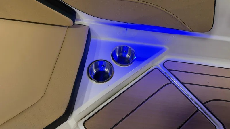 Slide: The Image of The 2027 Sea Ray SPX 210 features a sleek interior with blue LED lighting and cup holders. - 23