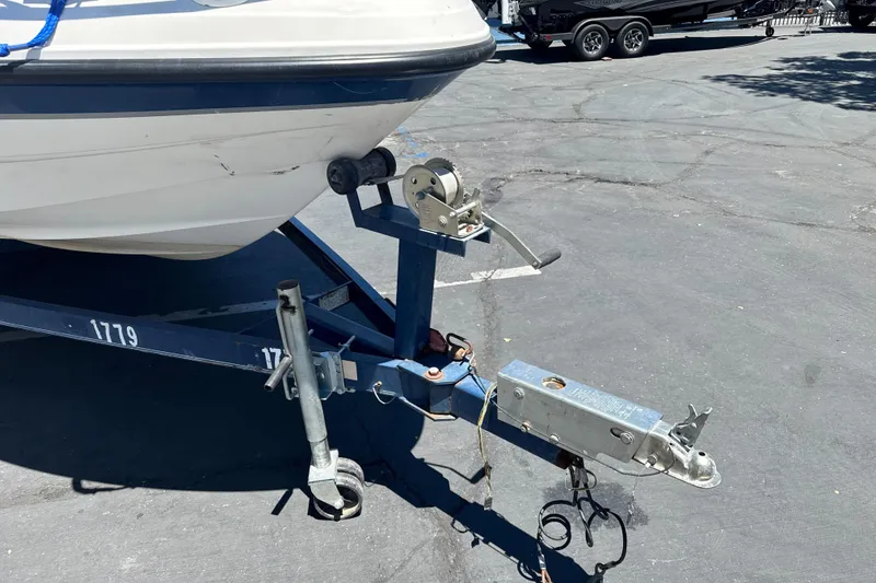 Slide: The Image of Trailer hitch of a 2002 Chaparral 205 SSe boat in a parking lot. - 3