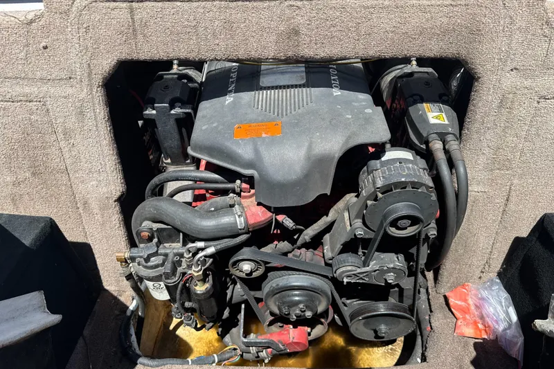 Slide: The Image of Engine compartment of a 2002 Chaparral 205 SSe boat, featuring a Volvo Penta engine. - 19
