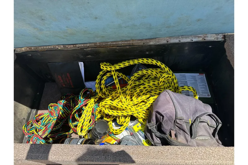 Slide: The Image of Storage compartment of a 2002 Chaparral 205 SSe boat with ropes and gear. - 16
