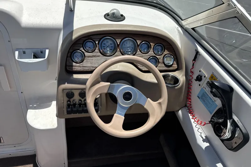 Slide: The Image of Steering console of a 2002 Chaparral 205 SSe boat with gauges and controls. - 12