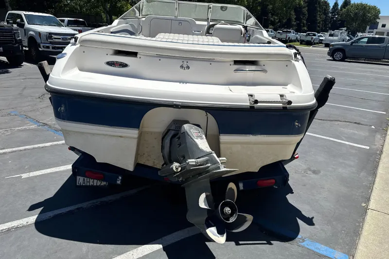 Slide: The Image of 2002 Chaparral 205 SSe boat in parking lot, rear view with visible propeller. - 7