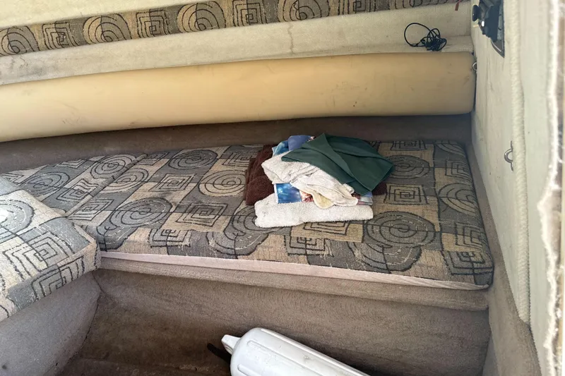 Slide: The Image of Interior cabin of a 2002 Chaparral 205 SSe boat with patterned cushions and folded towels. - 24