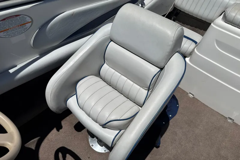Slide: The Image of 2002 Chaparral 205 SSe boat interior with plush, white leather seating and blue accents. - 13