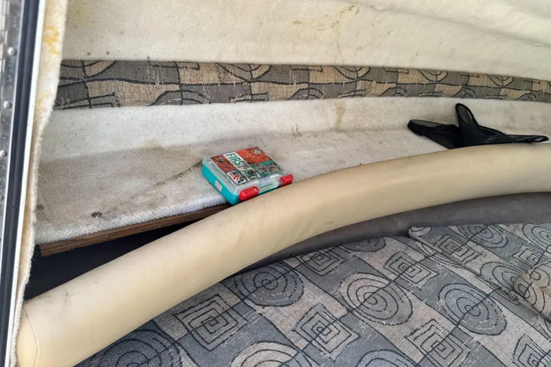 Slide: The Image of Interior of 2002 Chaparral 205 SSe boat with first aid kit and patterned upholstery. - 23