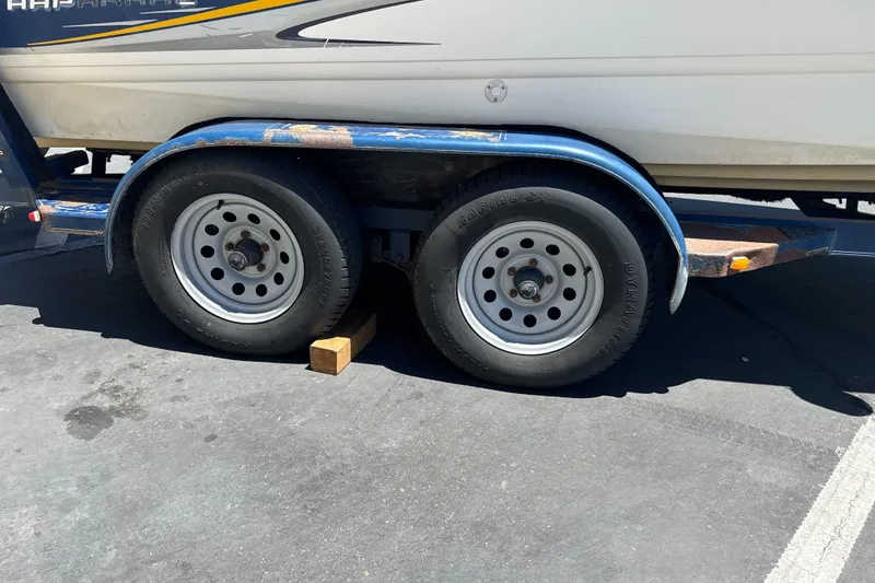 Slide: The Image of Trailer of a 2002 Chaparral 205 SSe boat with dual wheels on pavement. - 5
