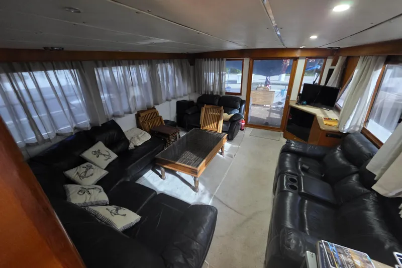Slide: The Image of Luxurious interior of a 2000 Ocean Alexander 60 Trawler with leather seating and nautical decor. - 12