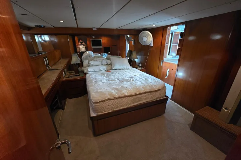 Slide: The Image of Luxurious bedroom interior of 2000 Ocean Alexander 60 Trawler with wood paneling and cozy bed. - 20