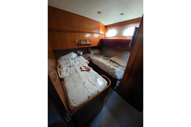 Slide: The Image of Interior cabin of 2000 Ocean Alexander 60 Trawler with twin beds and wooden paneling. - 26