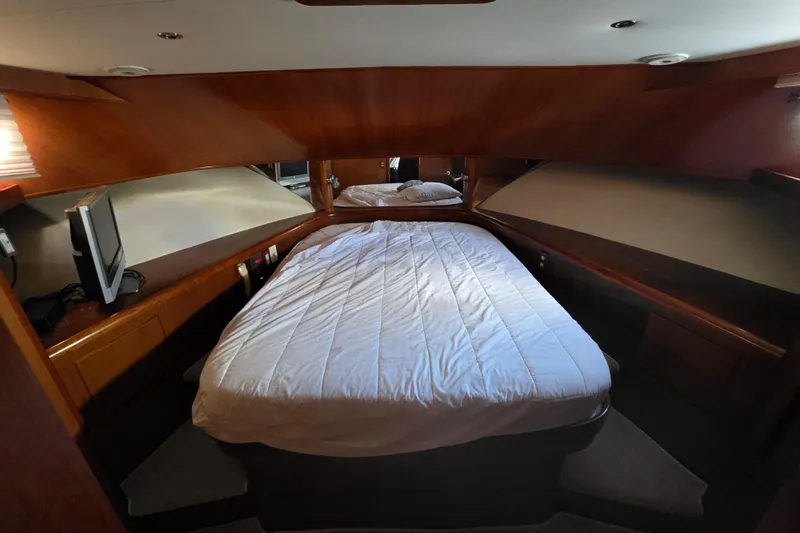 Slide: The Image of Luxurious cabin interior of 2000 Ocean Alexander 60 Trawler with cozy bed and wooden finish. - 23