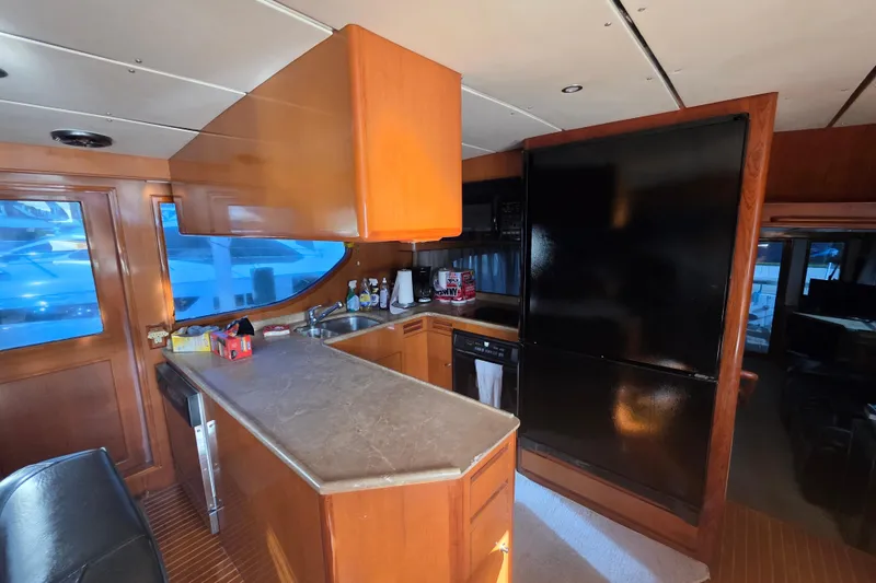 Slide: The Image of Interior of 2000 Ocean Alexander 60 Trawler kitchen with wooden cabinetry and modern appliances. - 16