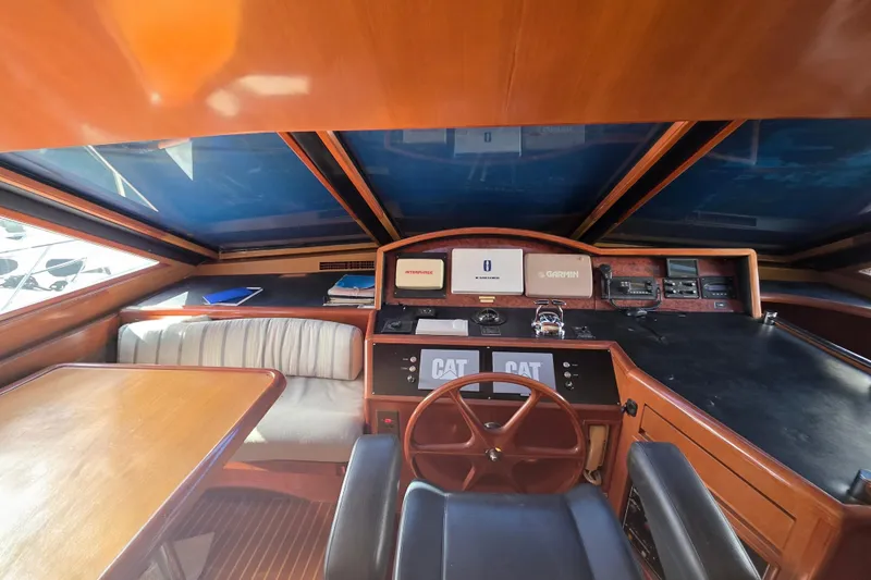 Slide: The Image of Interior helm of 2000 Ocean Alexander 60 Trawler with wooden accents and navigation equipment. - 18