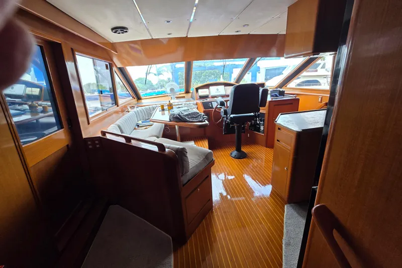 Slide: The Image of Interior of 2000 Ocean Alexander 60 Trawler with polished wood and helm station. - 14