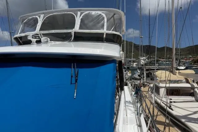 Slide: The Image of Ocean Alexander 60 Trawler, 2000 model, docked at marina with blue canopy. - 2