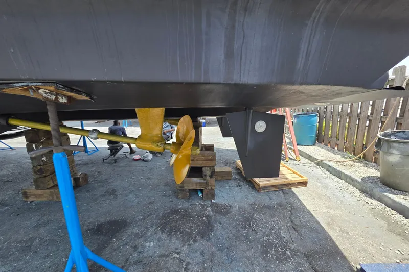 Slide: The Image of Ocean Alexander 60 Trawler 2000 under maintenance, showcasing propeller and hull details. - 36