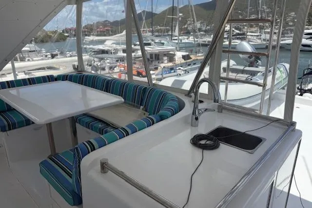 Slide: The Image of Luxurious Ocean Alexander 60 Trawler 2000 with spacious deck seating and marina view. - 9