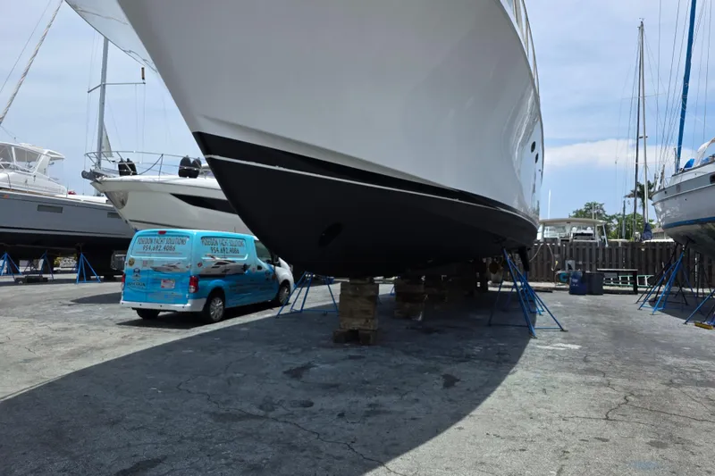 Slide: The Image of Ocean Alexander 60 Trawler 2000 on dry dock with service van nearby. - 28