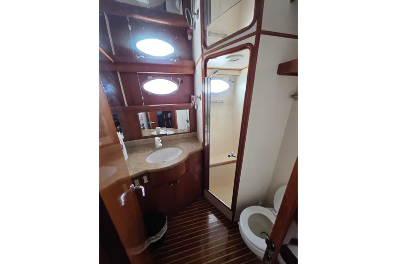 Slide: The Image of Luxurious bathroom in 2000 Ocean Alexander 60 Trawler with wood accents and modern fixtures. - 25
