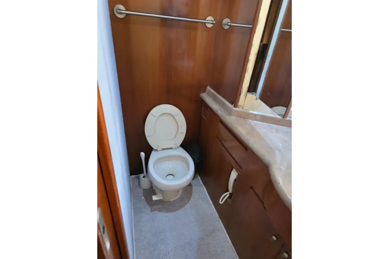 Slide: The Image of Bathroom interior of 2000 Ocean Alexander 60 Trawler with wooden cabinetry and toilet. - 22