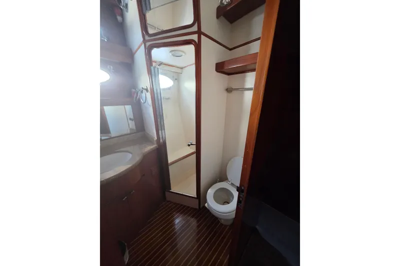 Slide: The Image of Bathroom interior of 2000 Ocean Alexander 60 Trawler with wooden accents and modern fixtures. - 24