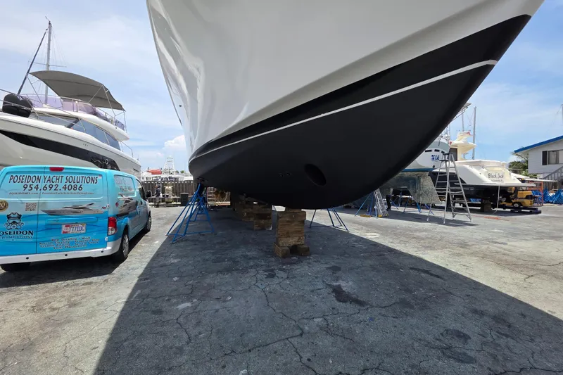 Slide: The Image of Ocean Alexander 60 Trawler 2000 in dry dock with yacht service van nearby. - 29