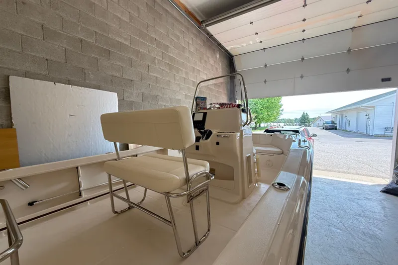 Slide: The Image of 2025 Grady-White Fisherman 180 boat in garage, showcasing interior seating and console. - 4