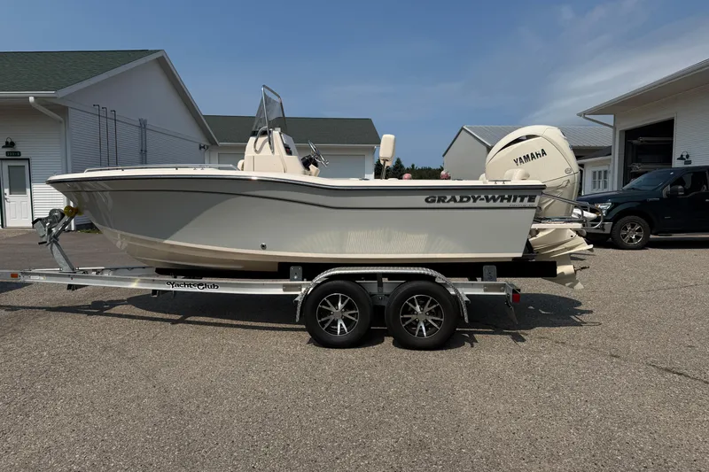 The Image of 2025 Grady-White Fisherman 180 boat on trailer, parked outdoors near buildings. - 0