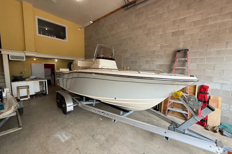 Slide: The Image of 2025 Grady-White Fisherman 180 boat on trailer in a garage setting. - 2