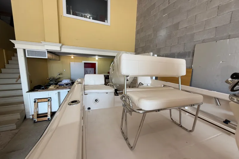 Slide: The Image of 2025 Grady-White Fisherman 180 boat interior with seating, in a garage setting. - 5