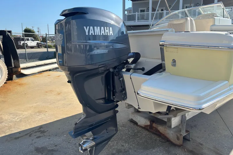 Slide: The Image of 2004 Scout 222 Dorado boat with Yamaha four-stroke outboard motor, docked outdoors. - 5