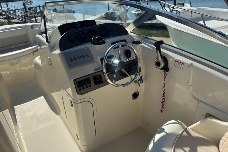 Slide: The Image of 2004 Scout 222 Dorado boat cockpit with Garmin navigation system and steering wheel. - 8