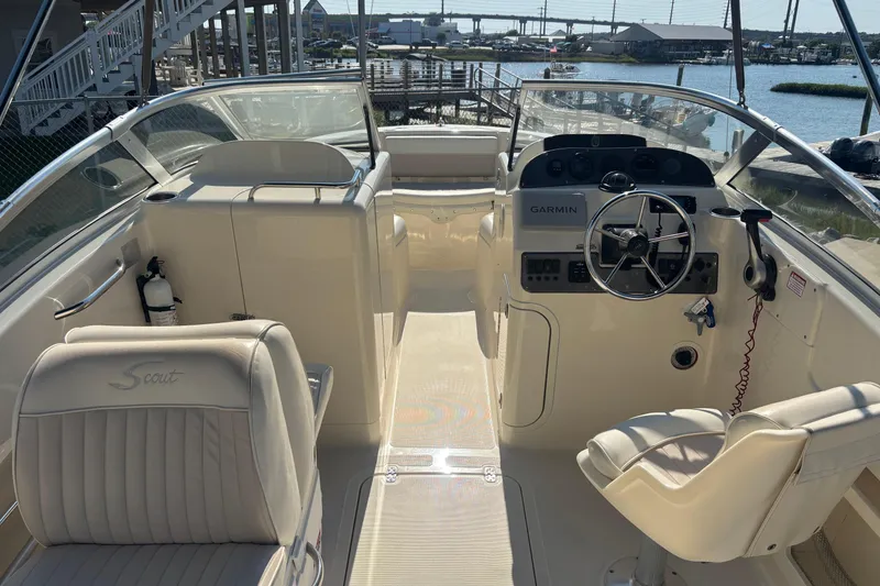 Slide: The Image of 2004 Scout 222 Dorado boat interior with steering wheel and Garmin navigation system. - 7