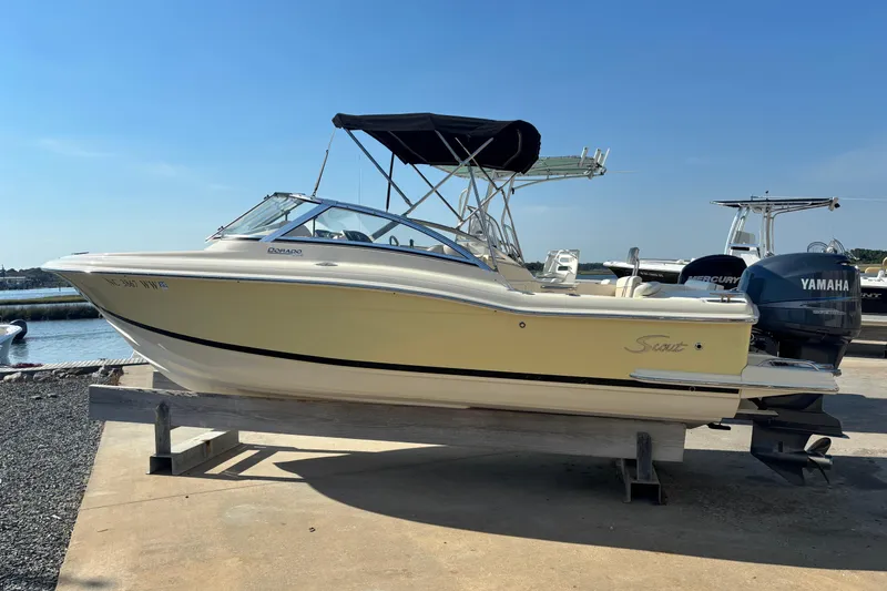 The Image of 2004 Scout 222 Dorado boat with Yamaha engines, docked under clear blue sky. - 0