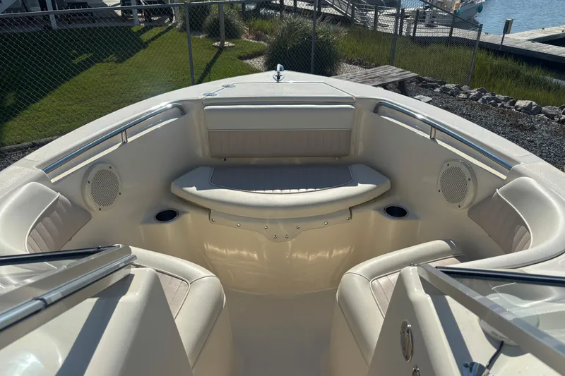Slide: The Image of 2004 Scout 222 Dorado boat interior with cushioned seating and cup holders. - 12