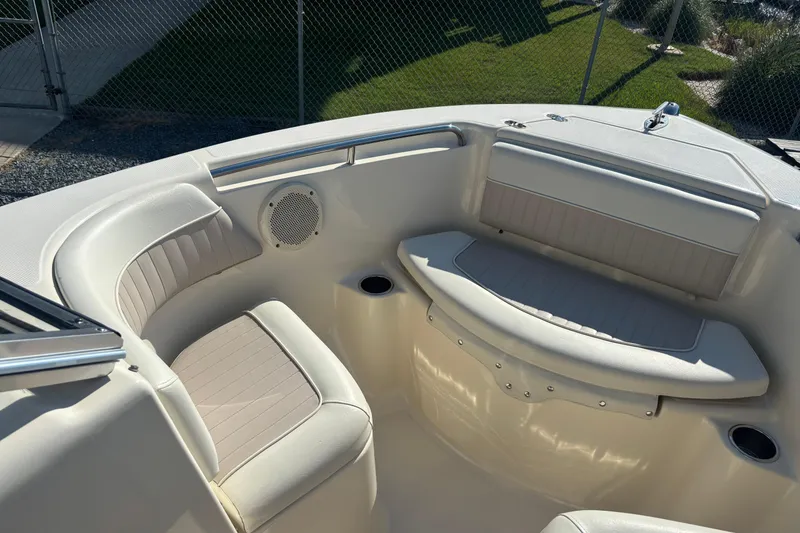 Slide: The Image of 2004 Scout 222 Dorado boat interior with cushioned seating and speaker. - 13