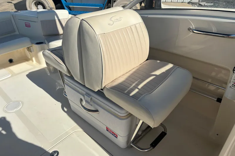 Slide: The Image of 2004 Scout 222 Dorado boat interior with beige seating and storage compartment. - 11