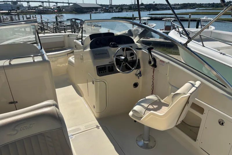 Slide: The Image of 2004 Scout 222 Dorado boat interior with steering wheel and Garmin navigation system. - 9