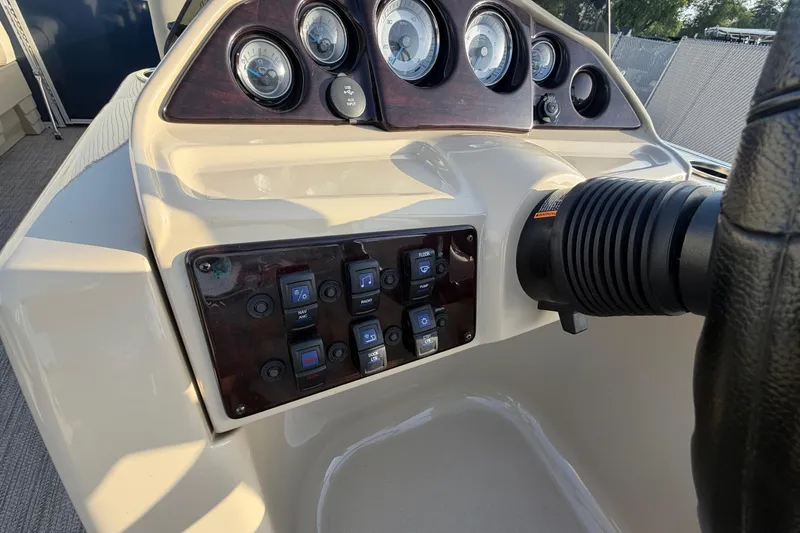 Slide: The Image of Dashboard of a 2018 Sylvan Mirage 820 Cruise boat with gauges and control switches. - 17