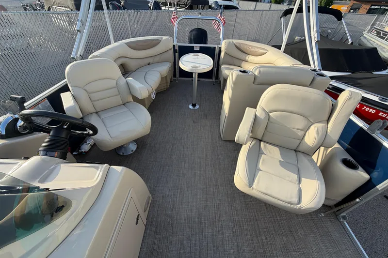 Slide: The Image of 2018 Sylvan Mirage 820 Cruise interior with plush seating and steering wheel. - 14