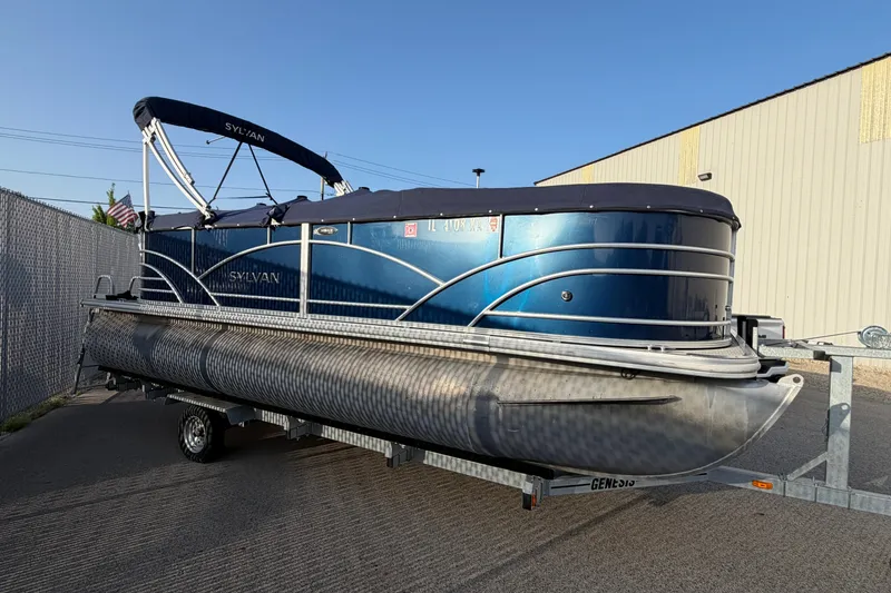 Slide: The Image of 2018 Sylvan Mirage 820 Cruise pontoon boat on trailer, parked outdoors. - 9