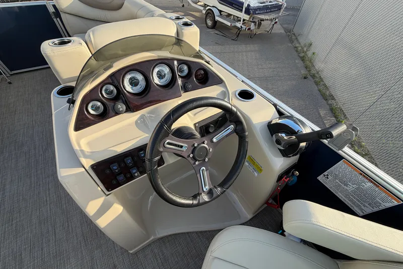 Slide: The Image of 2018 Sylvan Mirage 820 Cruise boat dashboard with steering wheel and control panel. - 16