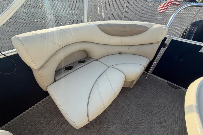 Slide: The Image of 2018 Sylvan Mirage 820 Cruise boat interior with beige seating and cup holders. - 11