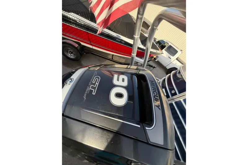 Slide: The Image of 2018 Sylvan Mirage 820 Cruise with Mercury 90 engine, American flag visible. - 25