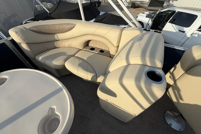 Slide: The Image of Luxurious seating on a 2018 Sylvan Mirage 820 Cruise pontoon boat with cup holders and table. - 12