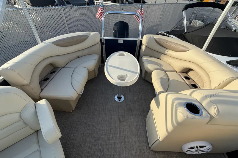 Slide: The Image of 2018 Sylvan Mirage 820 Cruise boat interior with beige seating and central table. - 10