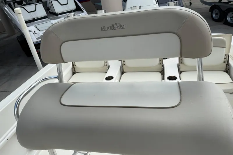 Slide: The Image of 2015 NauticStar 231 Coastal boat seat with white and beige upholstery. - 11
