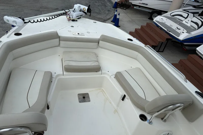 Slide: The Image of 2015 NauticStar 231 Coastal boat interior with seating and trolling motor. - 13