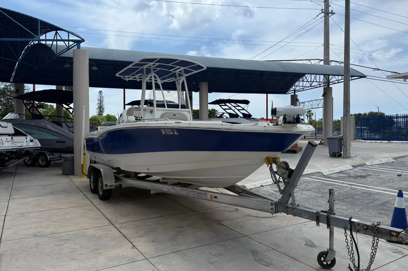 Slide: The Image of 2015 NauticStar 231 Coastal boat on trailer in marina parking area. - 5