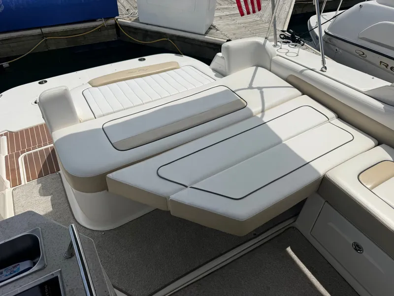 Slide: The Image of The image shows the cockpit of a Sea Ray Sundancer 310 with beige upholstery and a lounging area. - 20